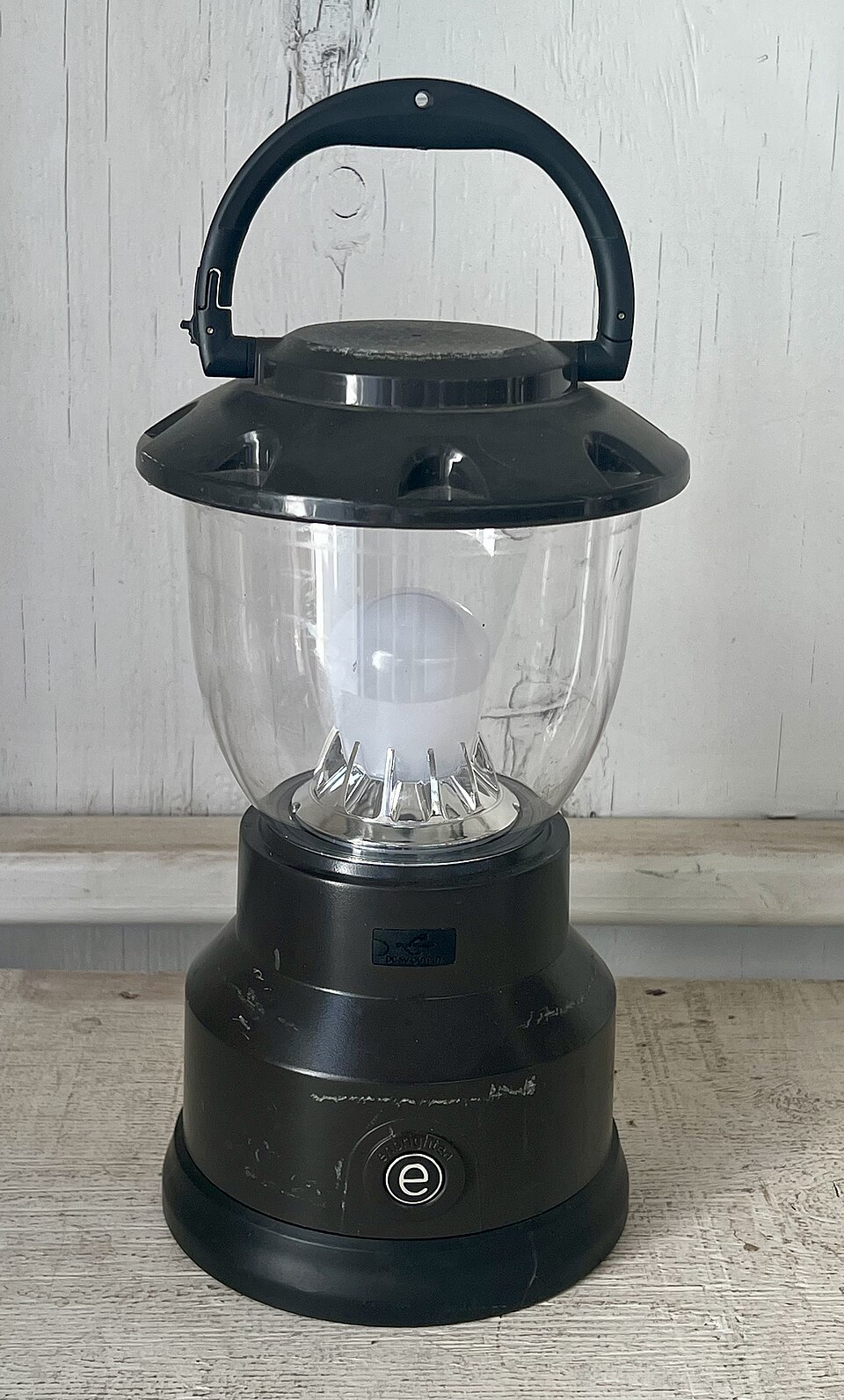 A black LED camping lantern with a clear globe and a top carry handle, for storm prep in Daphne, AL
